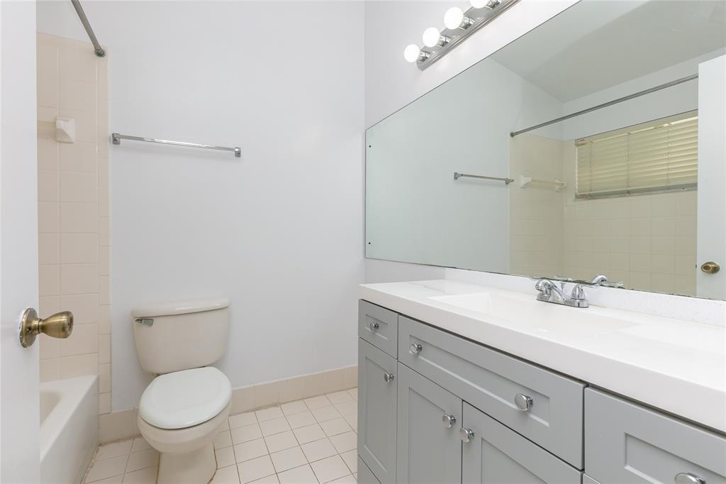 159 Hidden Ct Road, Unit I49 Hollywood, FL 33023 - Photo 18 of 21 a bathroom with a granite countertop toilet sink and mirror