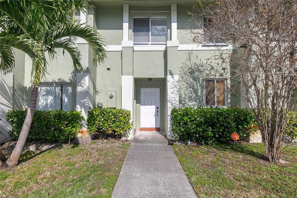 159 Hidden Ct Road, Unit I49 Hollywood, FL 33023 - Photo 2 of 21 front view of a house with a garden
