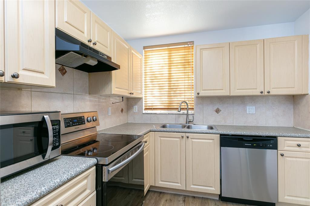 159 Hidden Ct Road, Unit I49 Hollywood, FL 33023 - Photo 3 of 21 a kitchen with white cabinets and a sink