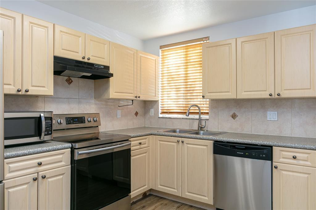 159 Hidden Ct Road, Unit I49 Hollywood, FL 33023 - Photo 5 of 21 a kitchen with stainless steel appliances granite countertop white cabinets and a stove a sink