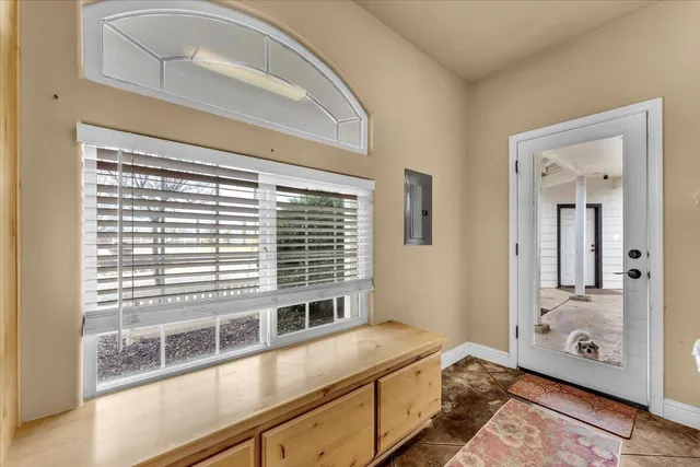 a living room with stainless steel appliances furniture or kitchen view and a refrigerator