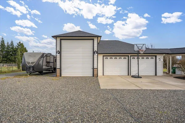 a kitchen with stainless steel appliances granite countertop a refrigerator a stove and a cabinets with wooden floor