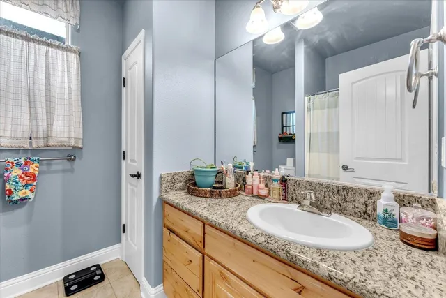 a view of a patio with table and chairs potted plants and wooden fence