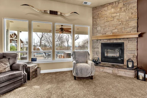 a living room with furniture a flat screen tv and a fireplace