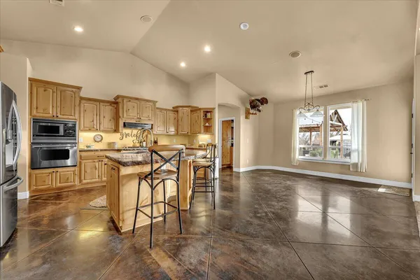 a kitchen with stainless steel appliances a refrigerator sink and cabinets