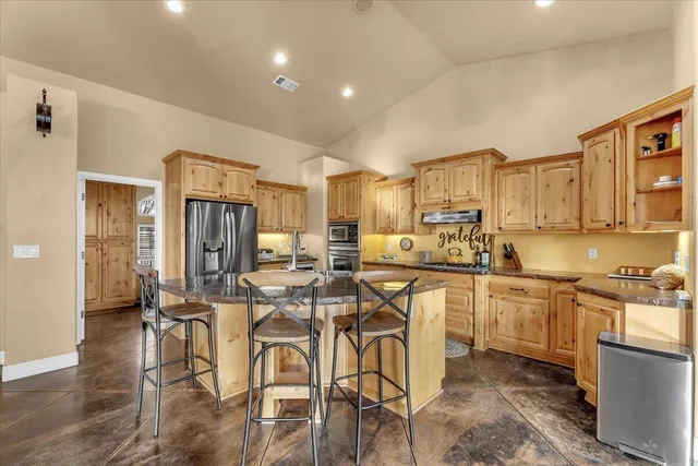 a kitchen with stainless steel appliances granite countertop a sink and cabinets