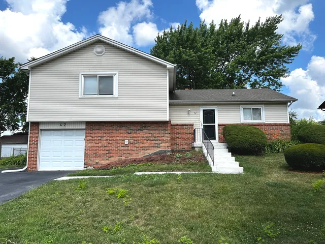 a front view of house with yard and green space