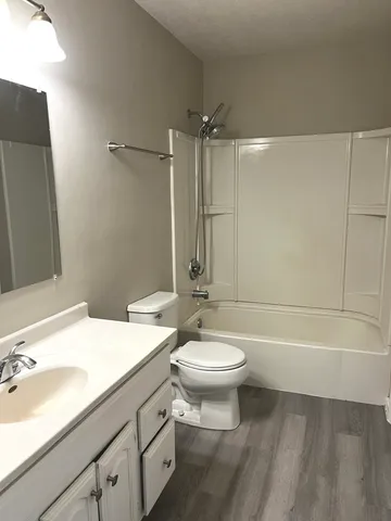 an empty room with closet and a window