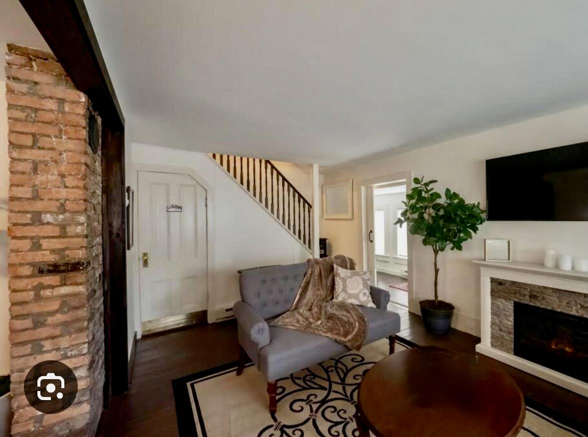 21 Mitchell Avenue Callicoon, NY 12723 - Photo 17 of 33 Living area featuring wood finished floors, stairs, and a stone fireplace