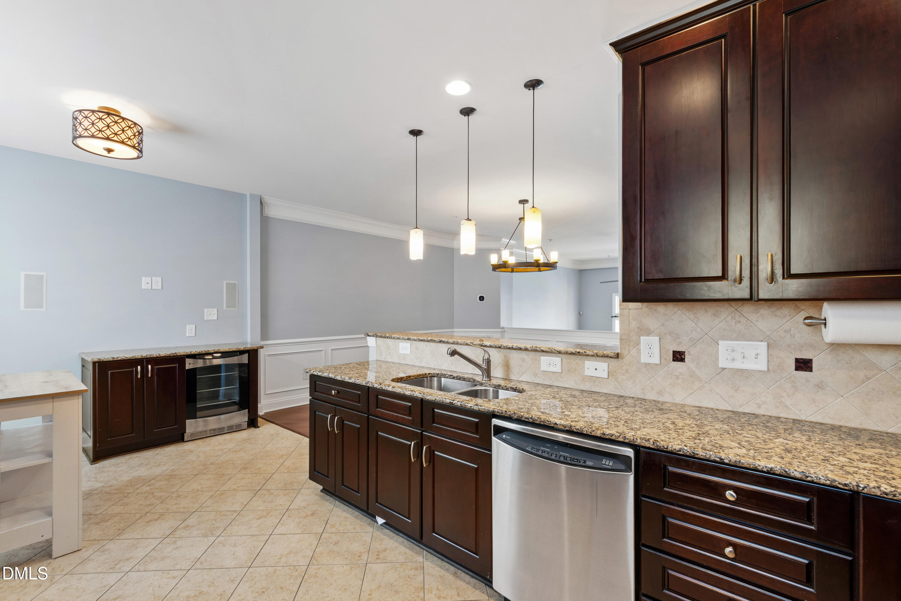 10321 Sablewood Drive, Unit 108 Raleigh, NC 27617 - Photo 13 of 41 a kitchen with stainless steel appliances granite countertop a sink a stove and a wooden cabinets