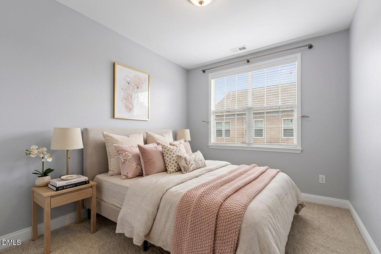 10321 Sablewood Drive, Unit 108 Raleigh, NC 27617 - Photo 30 of 41 a bedroom with a bed and wooden floor