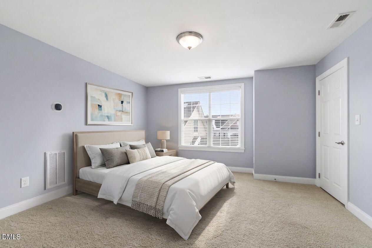 10321 Sablewood Drive, Unit 108 Raleigh, NC 27617 - Photo 32 of 41 a bedroom with a bed and a window
