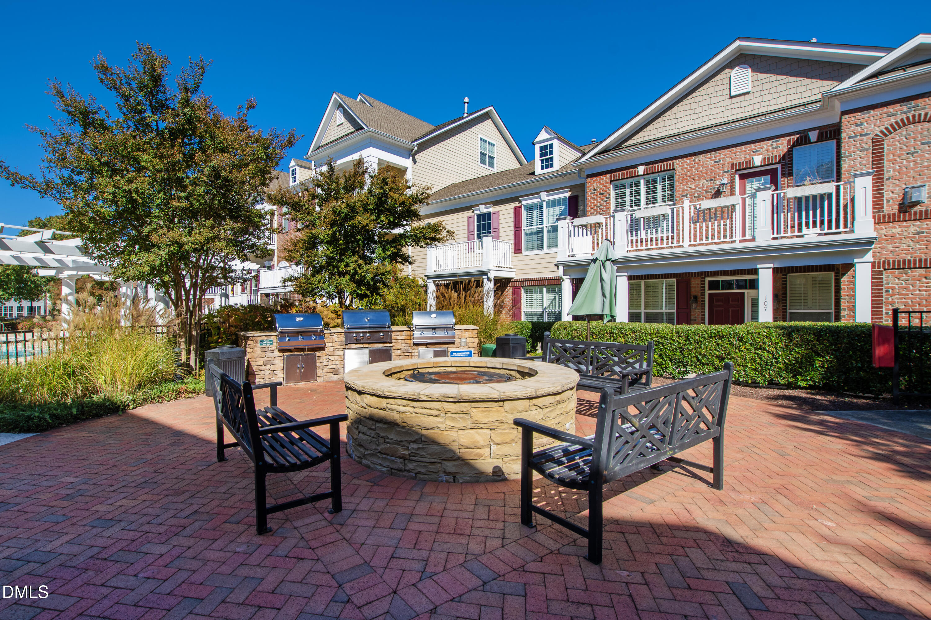 10321 Sablewood Drive, Unit 108 Raleigh, NC 27617 - Photo 40 of 41 a view of a patio with table and chairs and potted plants