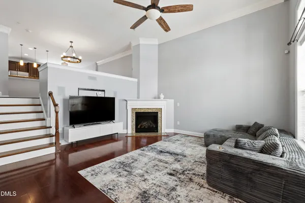 a living room with furniture a flat screen tv and a fireplace