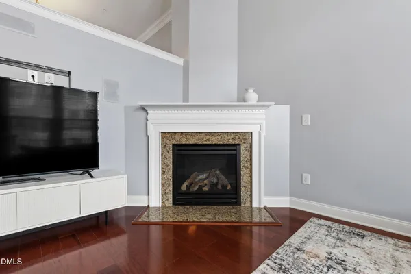 a living room with a fireplace and a flat screen tv