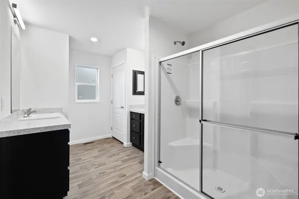 a bathroom with a shower sink and mirror