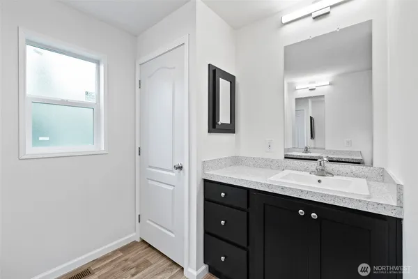 a bathroom with a double vanity sink and a mirror