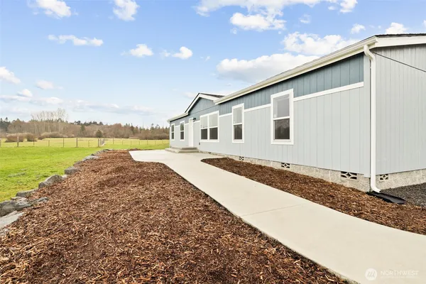 a view of a house with a yard and ocean view