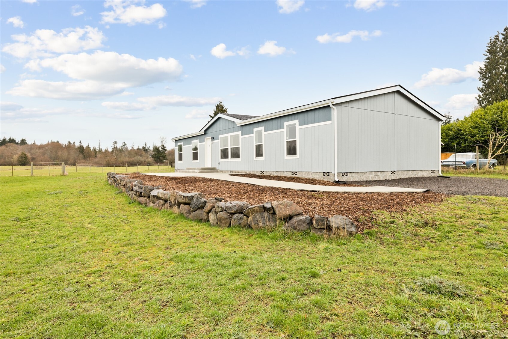 591 North Lees Creek Road Port Angeles, WA 98362 - Photo 39 of 39 a white house with a big yard and plants