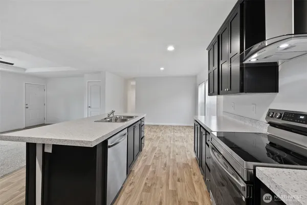 a kitchen with a sink and a stove top oven