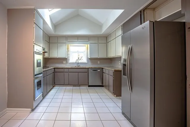 a kitchen with stainless steel appliances granite countertop a refrigerator sink and cabinets