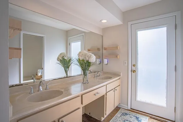 a bathroom with a double vanity sink and a mirror