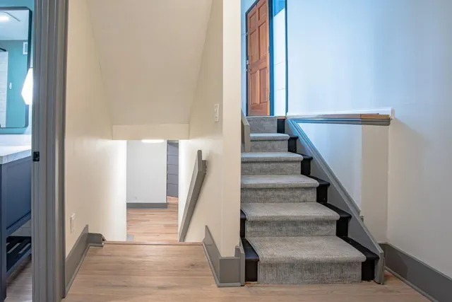 a view of staircase with white walls and a window