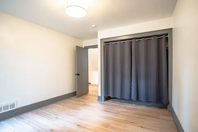 a view of a room with wooden floor