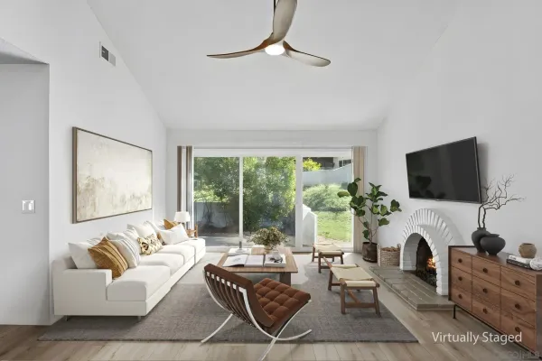 a living room with furniture a flat screen tv and a large window