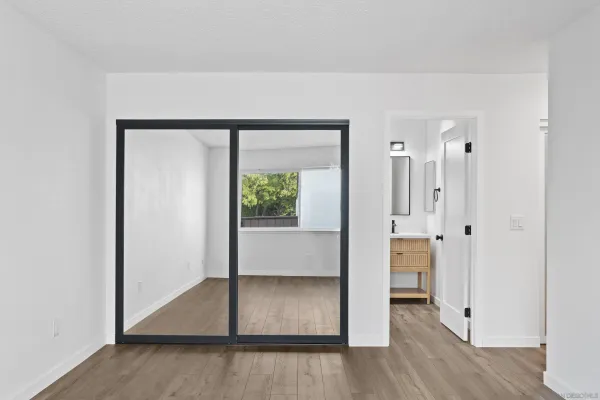 an entryway at an empty room and wooden floor