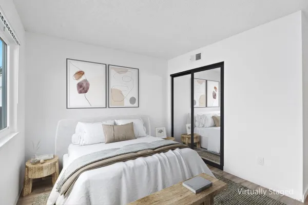 a bedroom with a bed and a painting on the wall