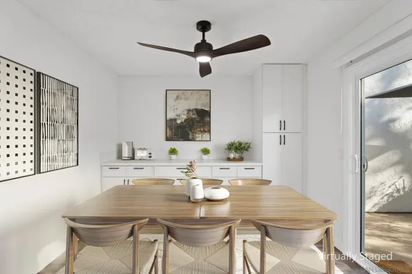 a view of a dining room with furniture and a chandelier