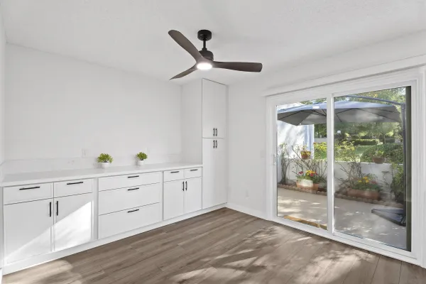 a view of a hardwood floor and window in a room