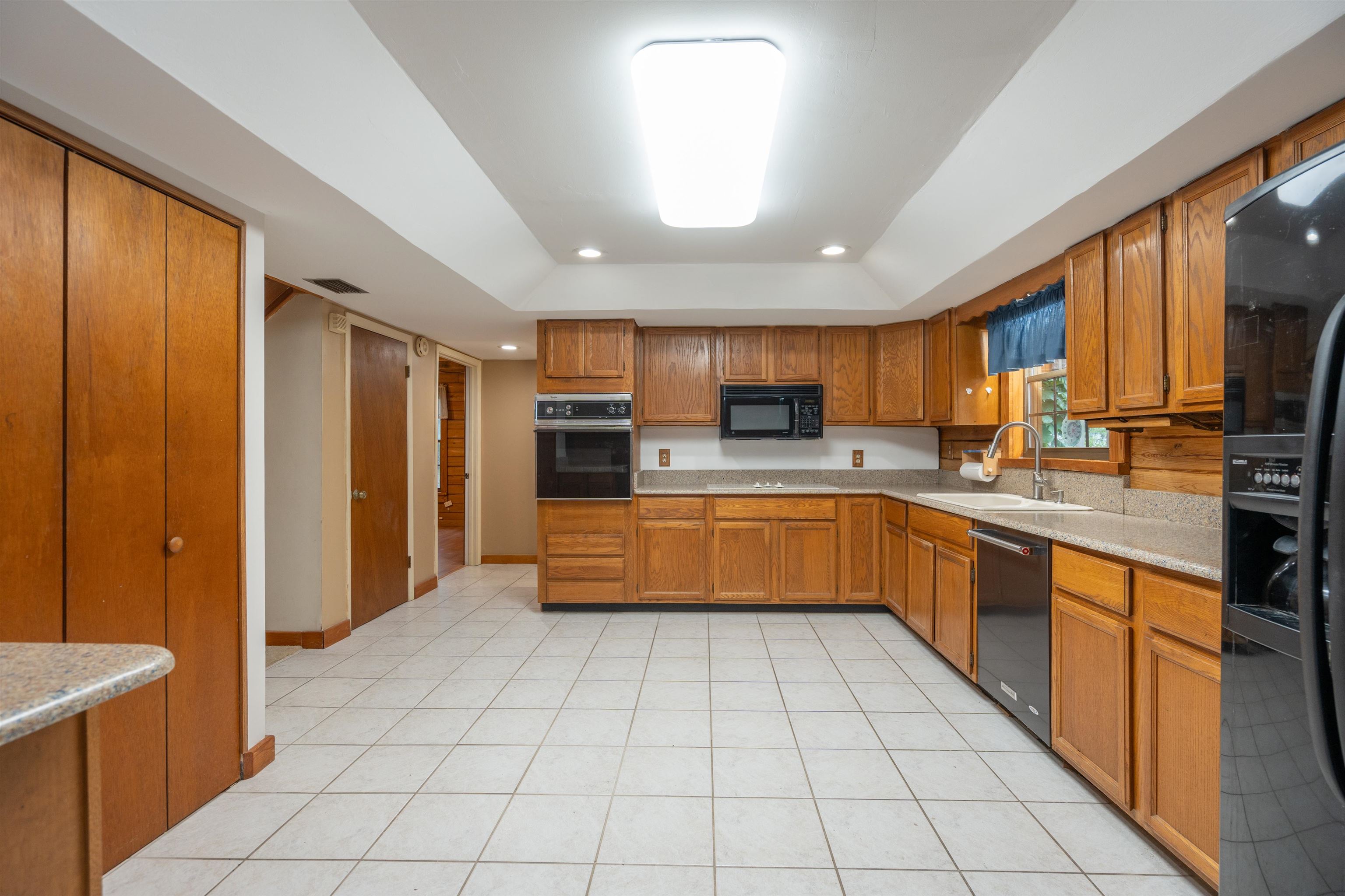 5850 Capo Island Road St. Augustine, FL 32095 - Photo 12 of 39 a kitchen with stainless steel appliances a refrigerator sink and cabinets