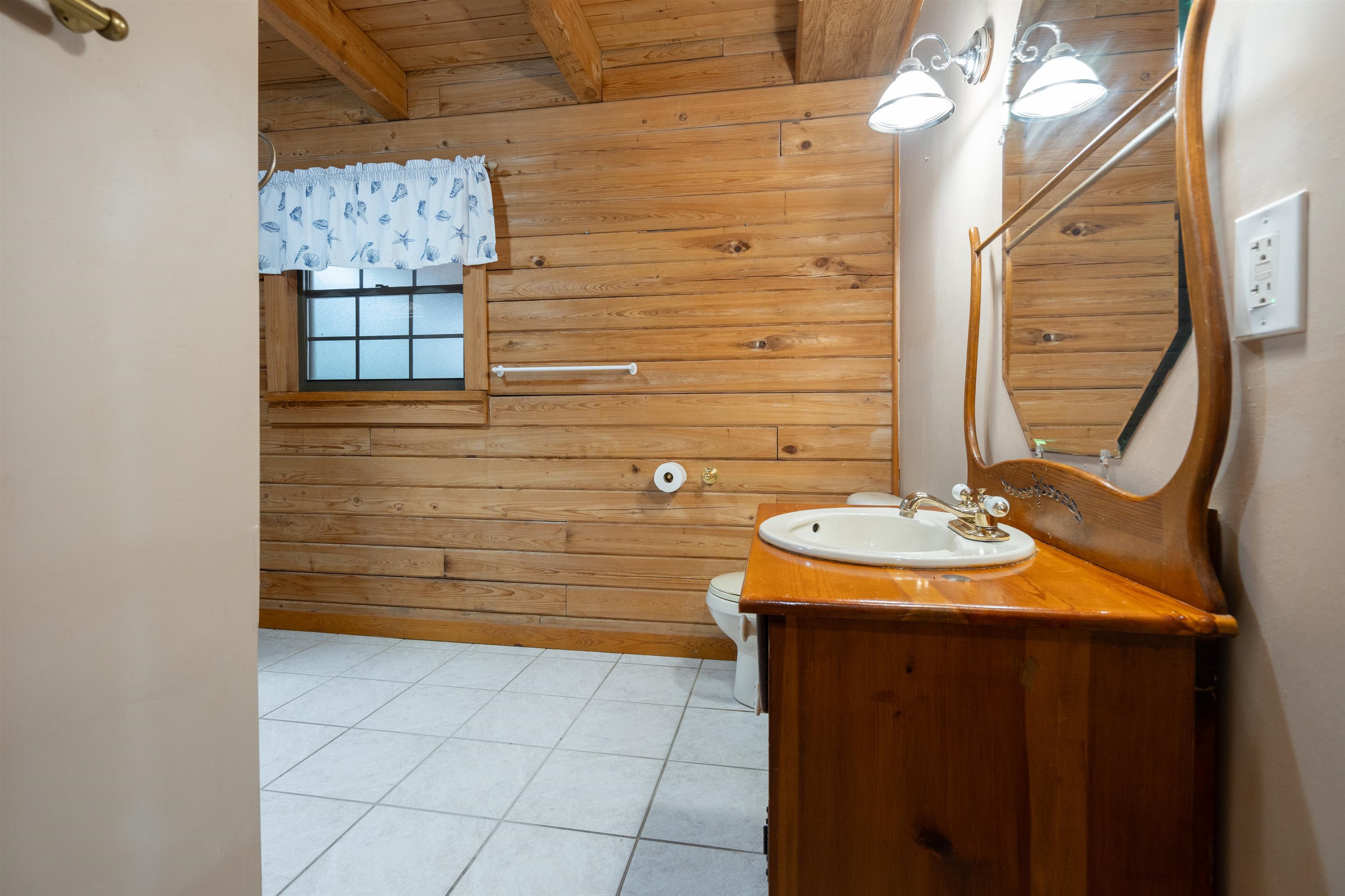 5850 Capo Island Road St. Augustine, FL 32095 - Photo 18 of 39 a bathroom with a sink and a mirror
