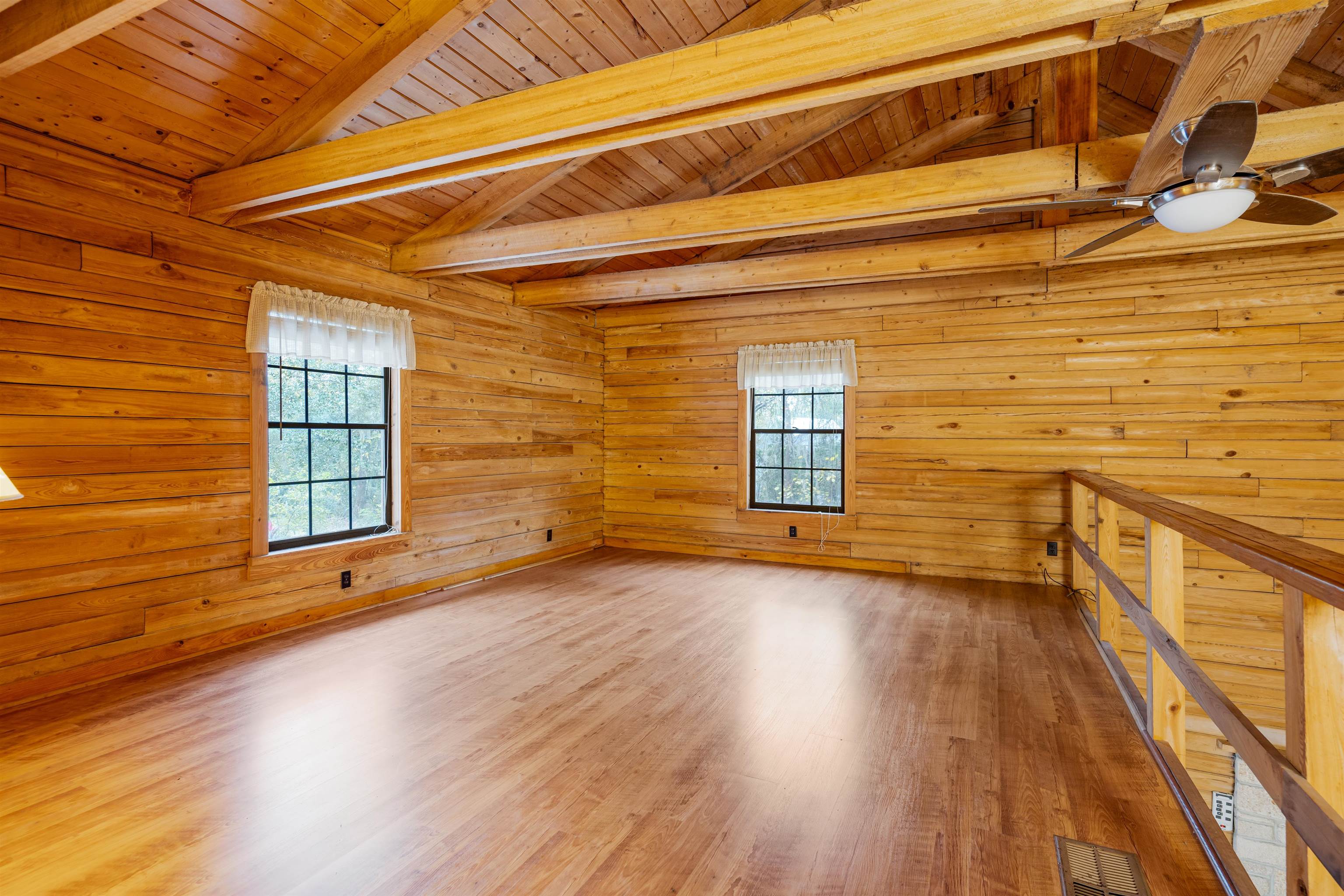5850 Capo Island Road St. Augustine, FL 32095 - Photo 23 of 39 a view of an empty room with wooden floor and a window