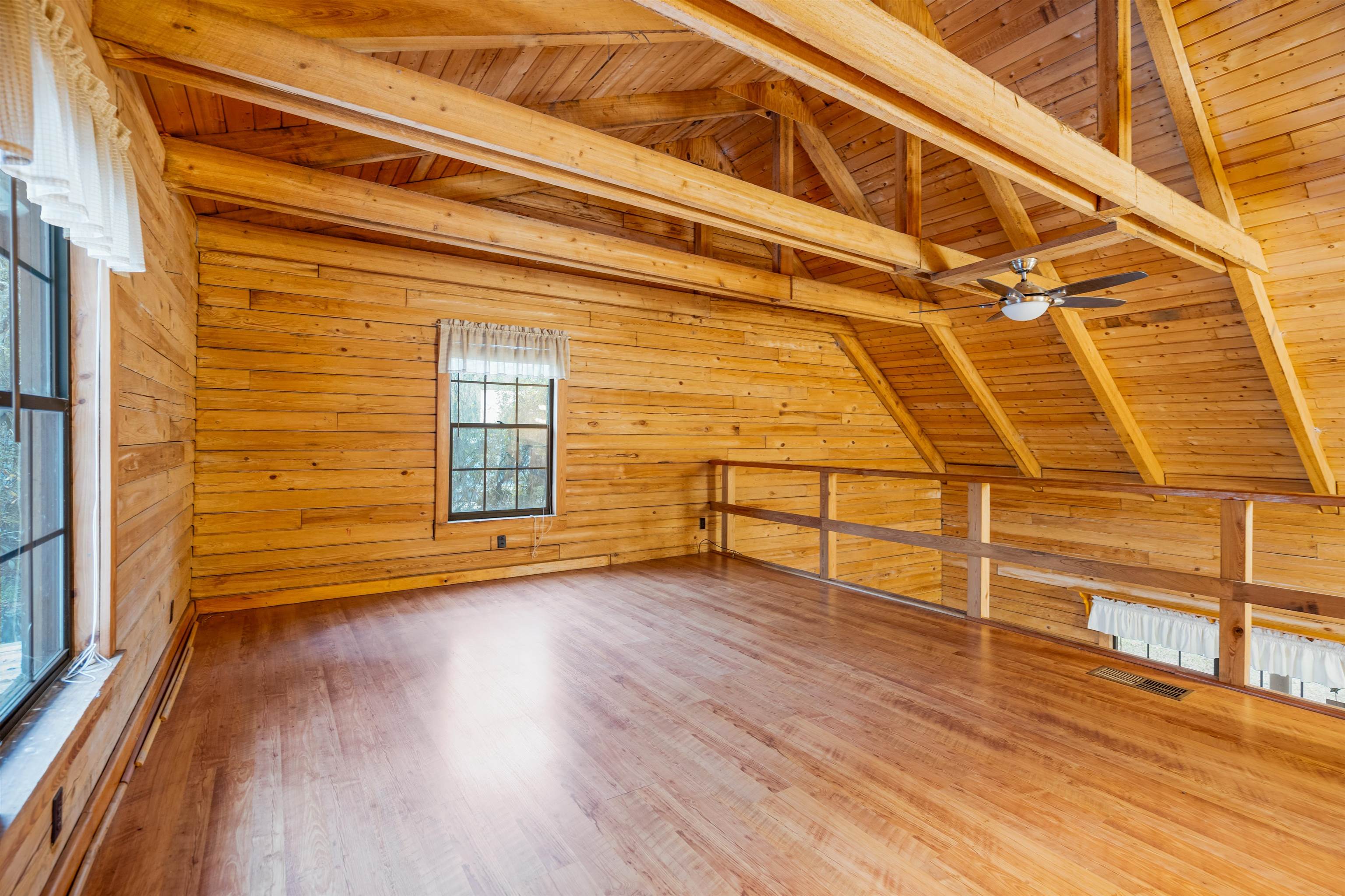 5850 Capo Island Road St. Augustine, FL 32095 - Photo 24 of 39 a view of an empty room with wooden floor and a window