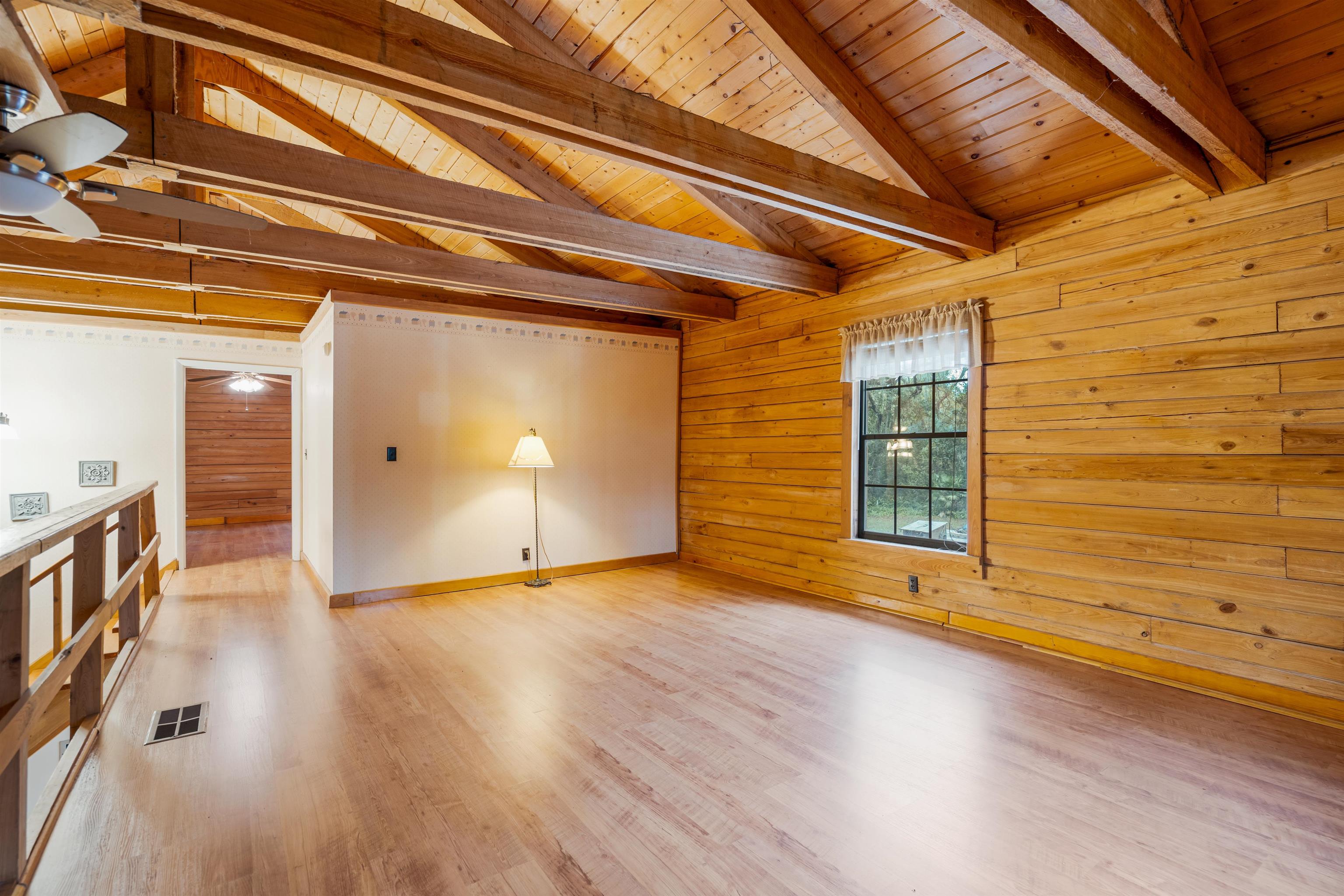 5850 Capo Island Road St. Augustine, FL 32095 - Photo 26 of 39 a view of an empty room with wooden floor and a window