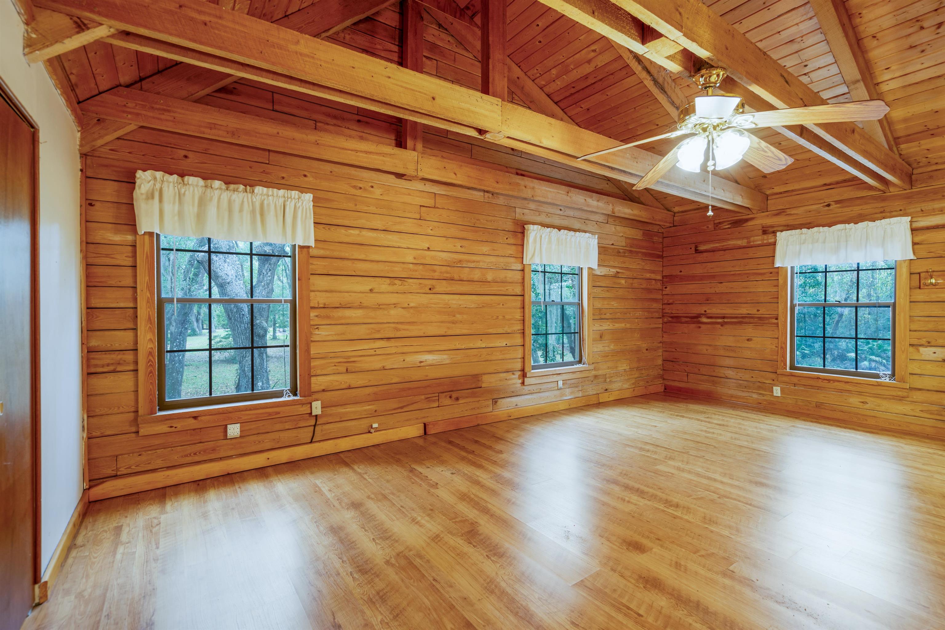5850 Capo Island Road St. Augustine, FL 32095 - Photo 28 of 39 an empty room with wooden floor and windows