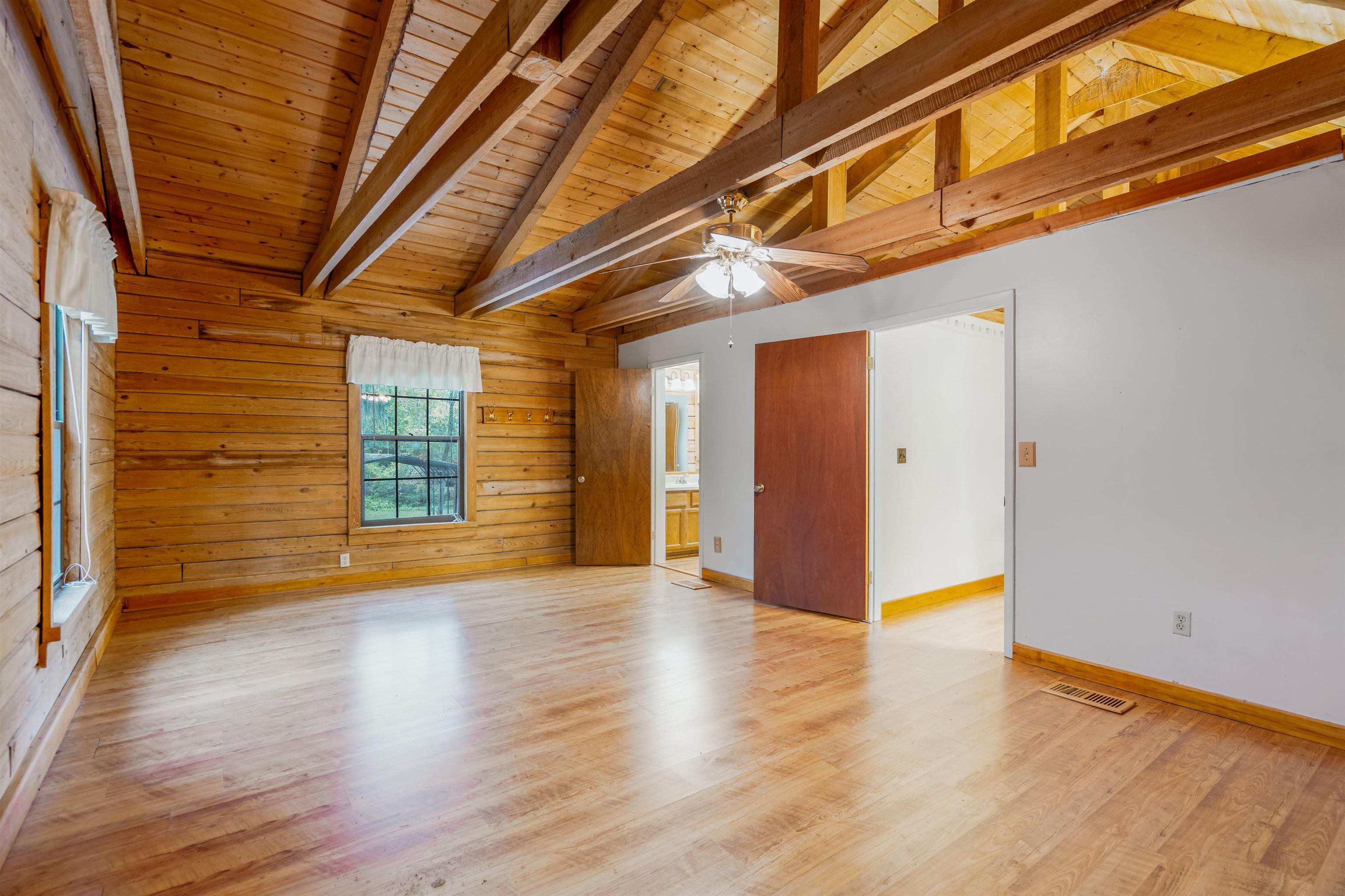 5850 Capo Island Road St. Augustine, FL 32095 - Photo 29 of 39 a view of an empty room with wooden floor and a window