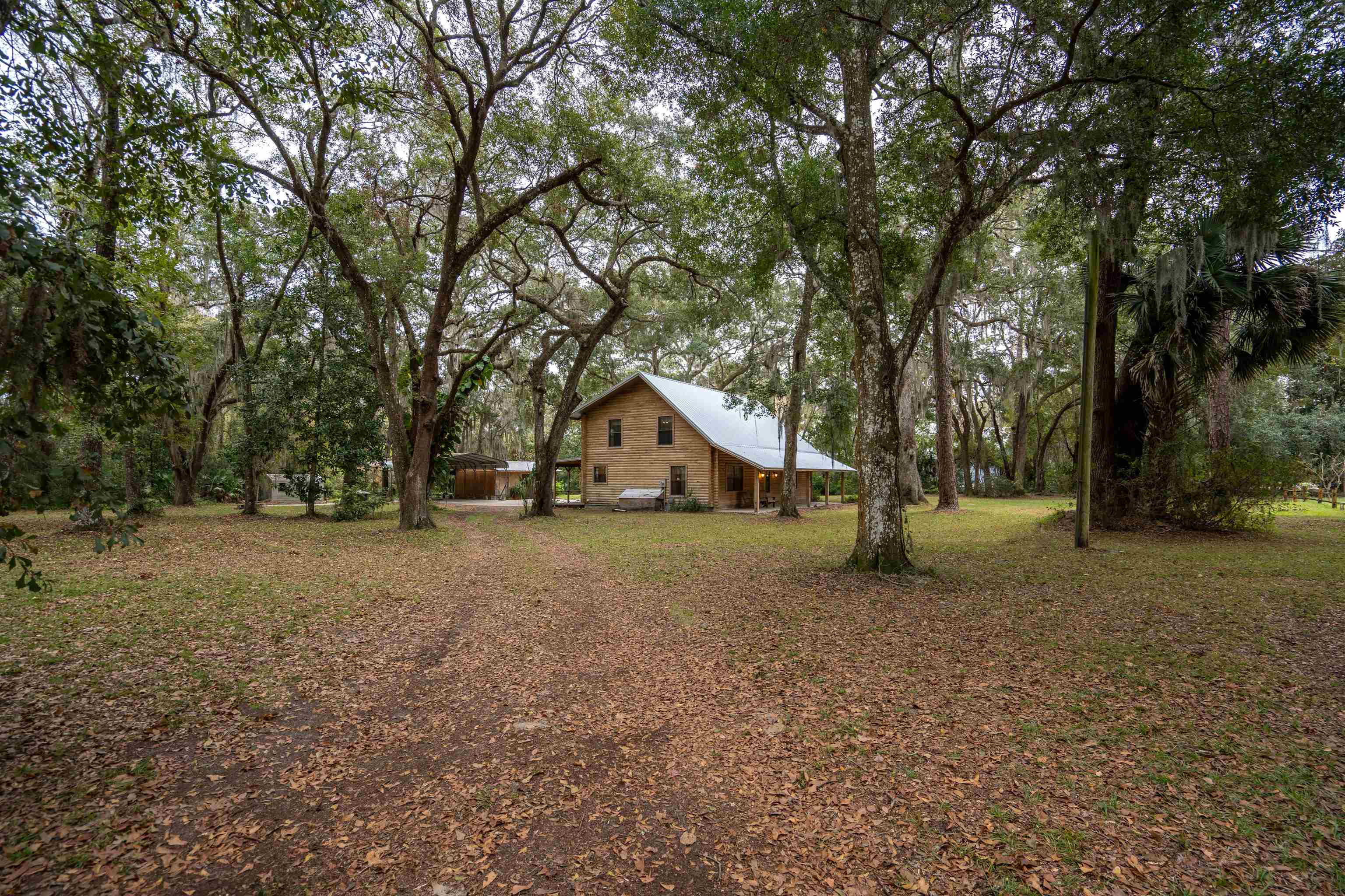 5850 Capo Island Road St. Augustine, FL 32095 - Photo 3 of 39 a house with trees in the background