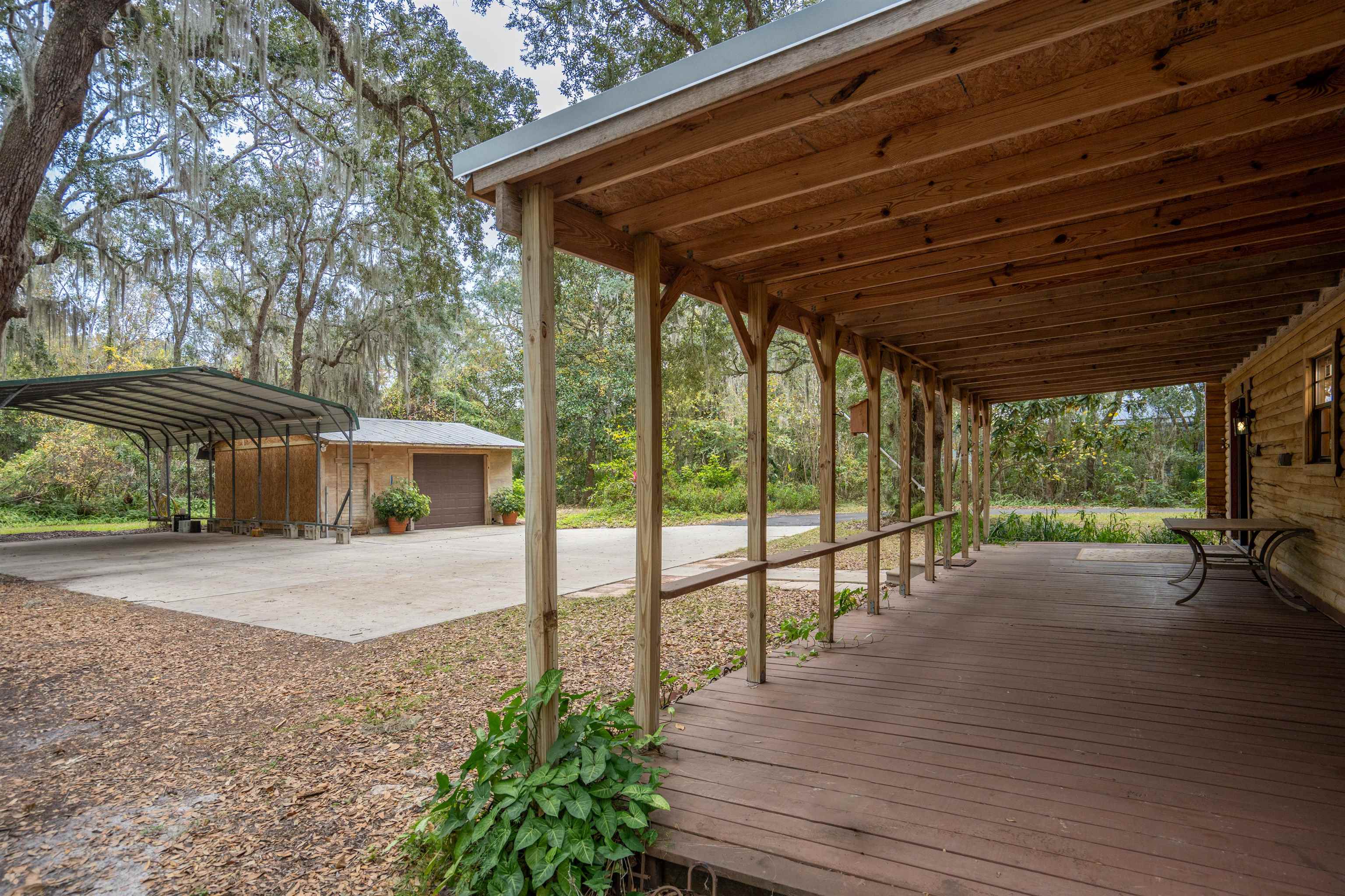 5850 Capo Island Road St. Augustine, FL 32095 - Photo 34 of 39 a view of a backyard with wooden floor and roof with a barbeque grill