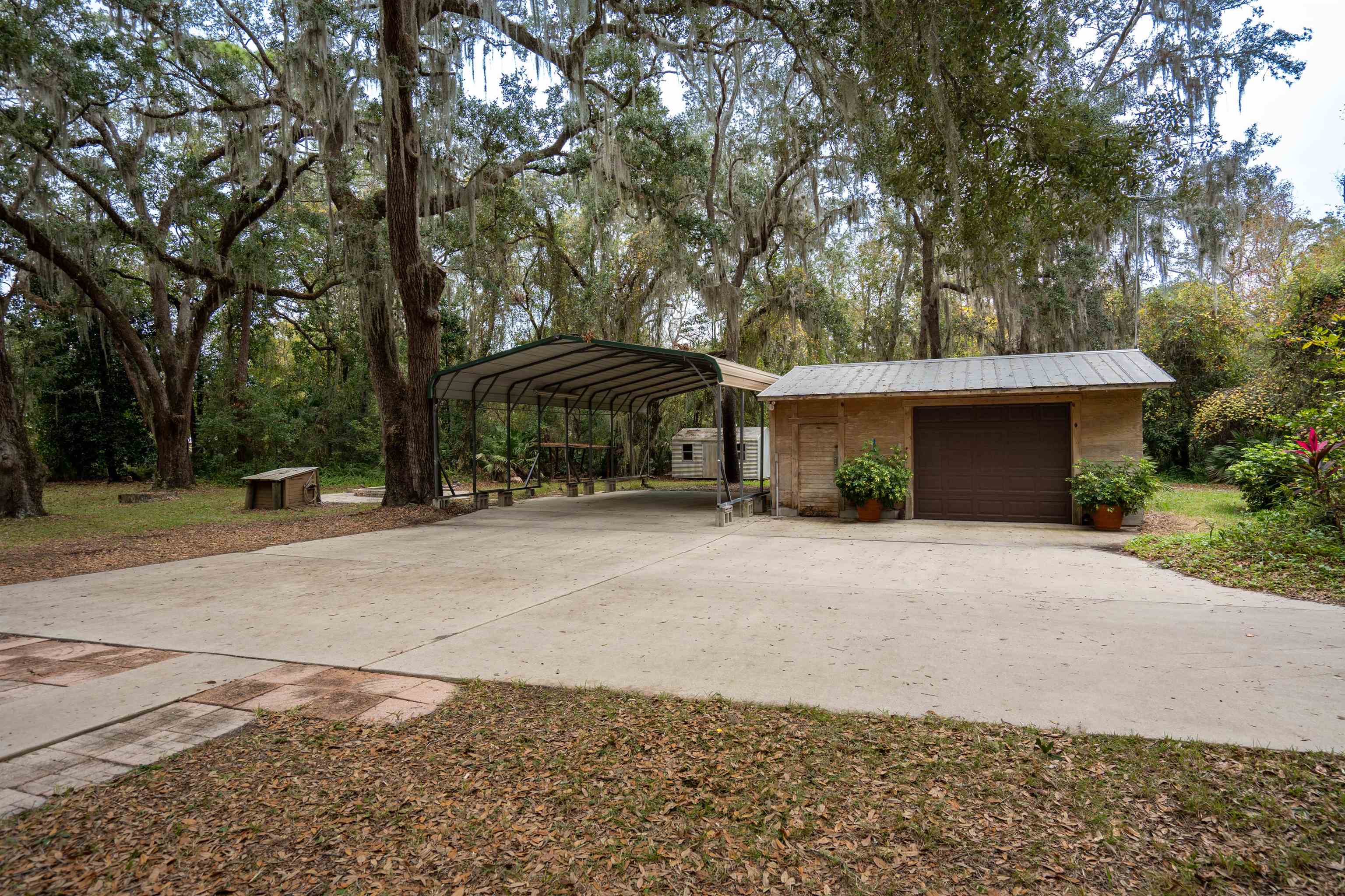 5850 Capo Island Road St. Augustine, FL 32095 - Photo 36 of 39 a front view of a house with a yard and garage