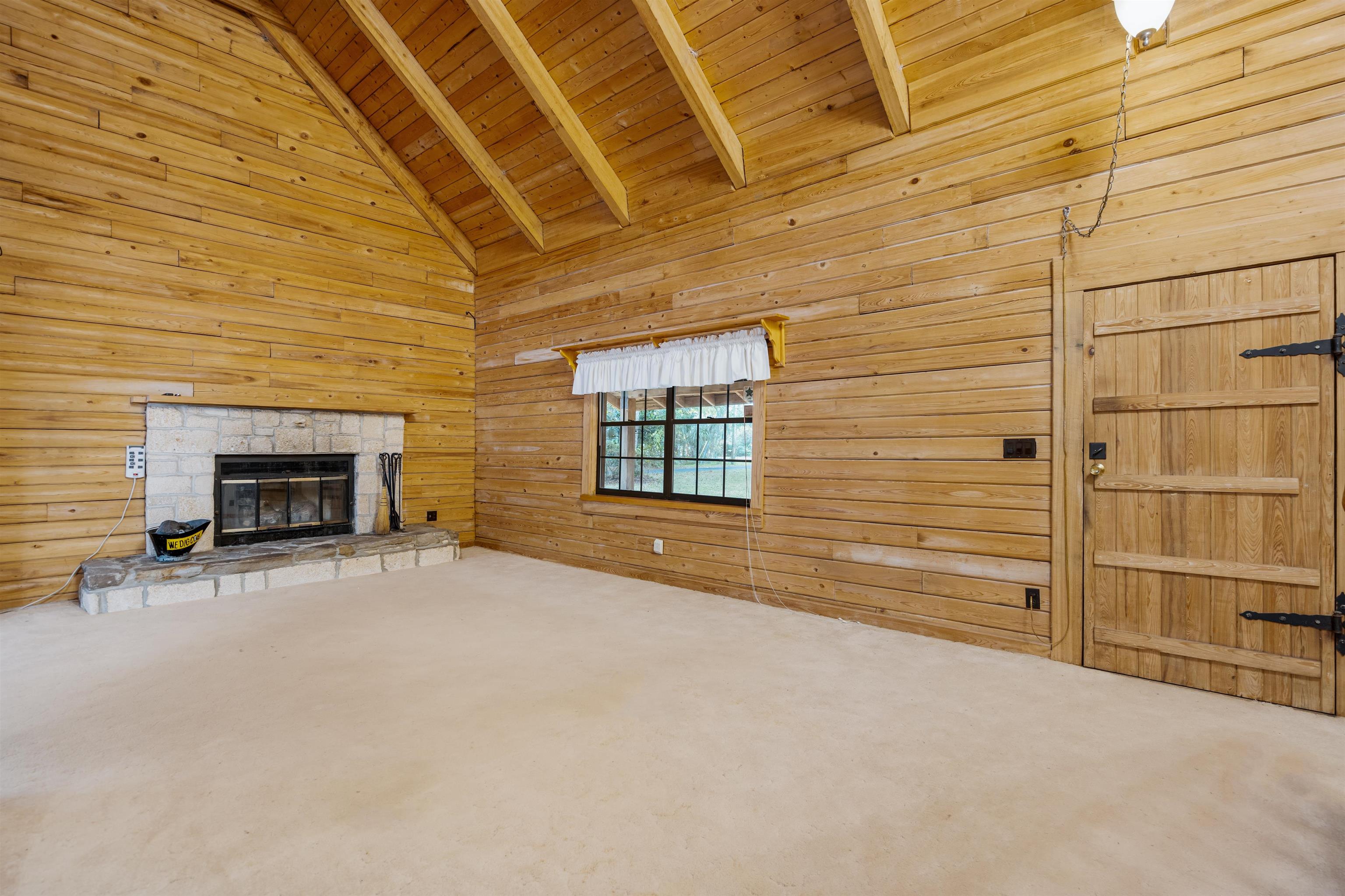5850 Capo Island Road St. Augustine, FL 32095 - Photo 9 of 39 a view of an empty room with a fireplace and a window