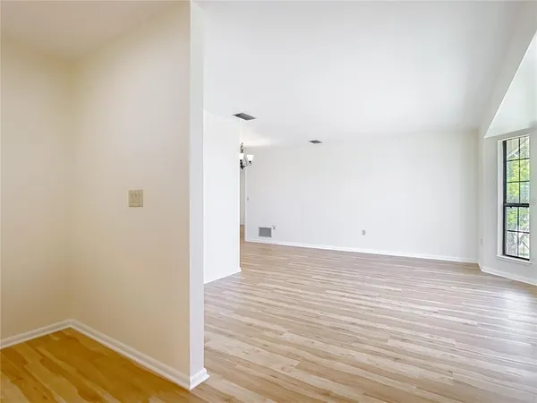 a kitchen with white cabinets and a stove with a sink