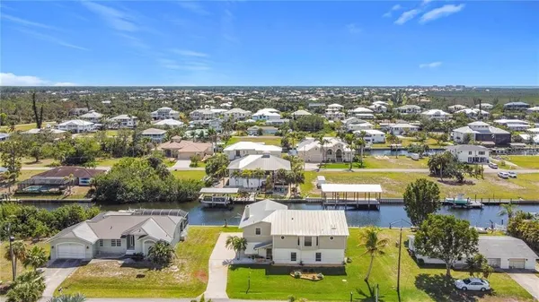 an aerial view of a houses with a swimming pool