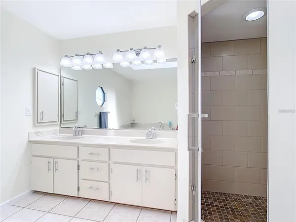 a view of a lake with a big yard and large trees