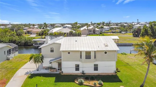 a view of a room with wooden floor and windows