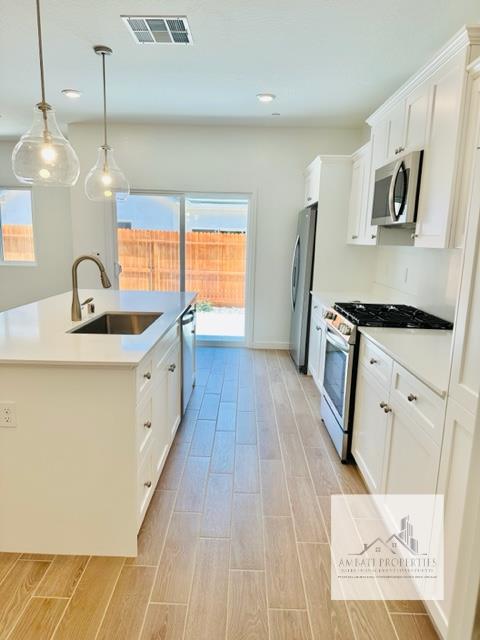334 Aria Avenue South Madera, CA 93636 - Photo 11 of 20 a kitchen with sink a refrigerator and wooden floor