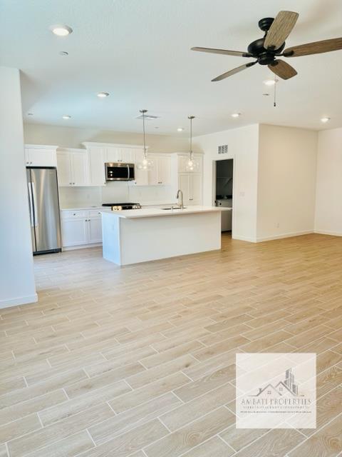 334 Aria Avenue South Madera, CA 93636 - Photo 8 of 20 a view of kitchen with stainless steel appliances kitchen island a sink dishwasher a refrigerator and a microwave